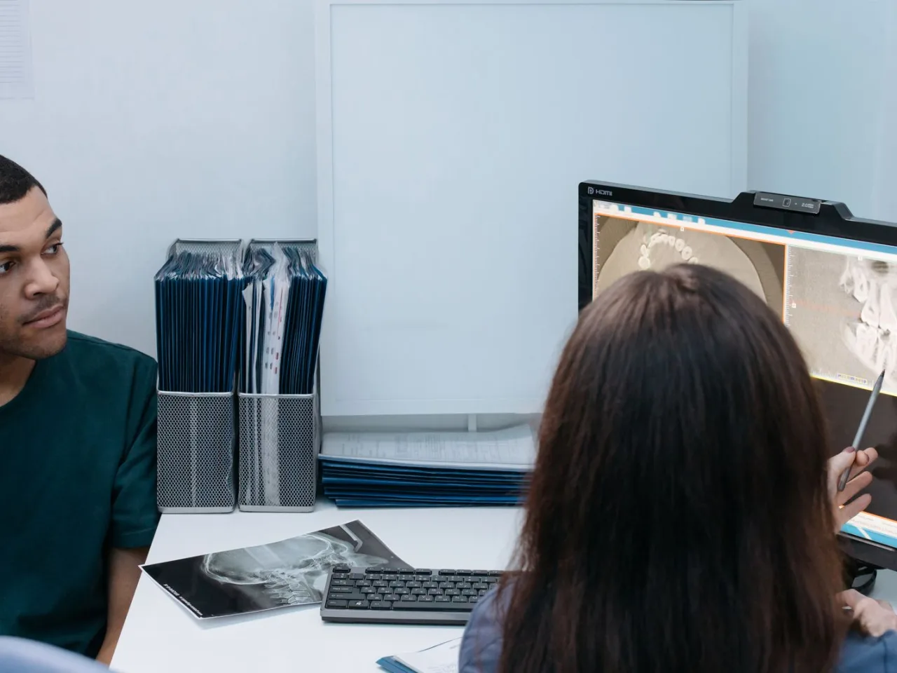 Dentist and patient reviewing a treatment plan over an X-ray